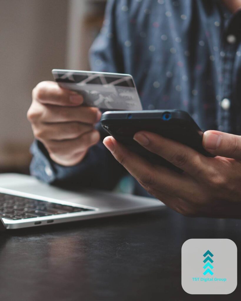 Man holding a credit card and smartphone, highlighting data-driven PPC management and advertising services by TST Digital Agency in Helotes, San Antonio, Texas.